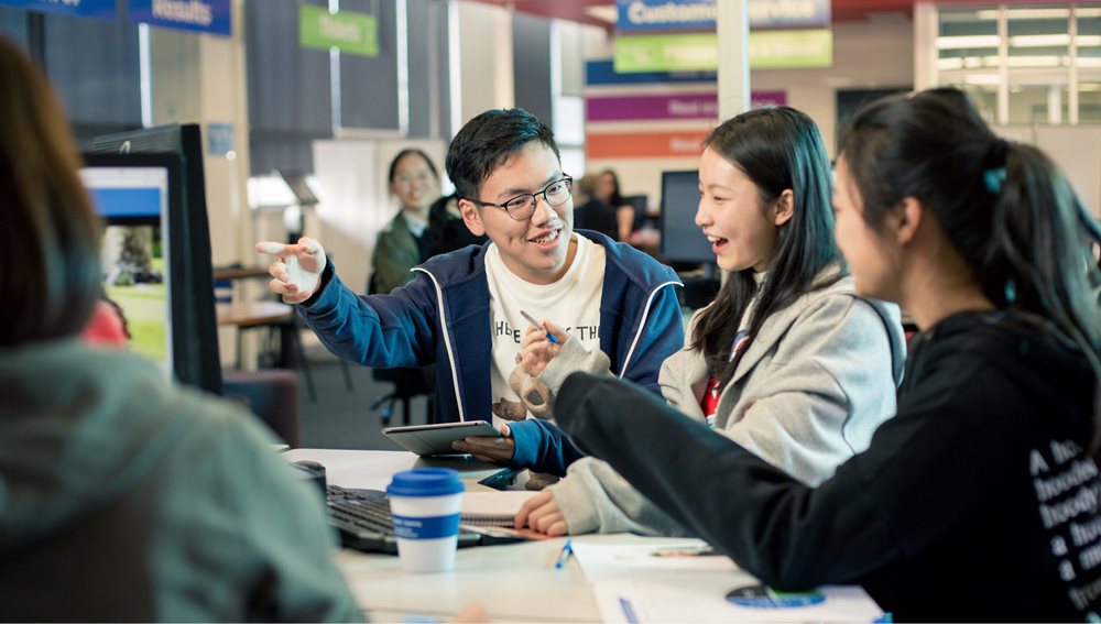 Image of lauging students in social environment.