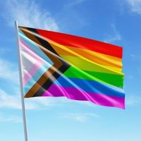 Progress Pride flag with blue sky background