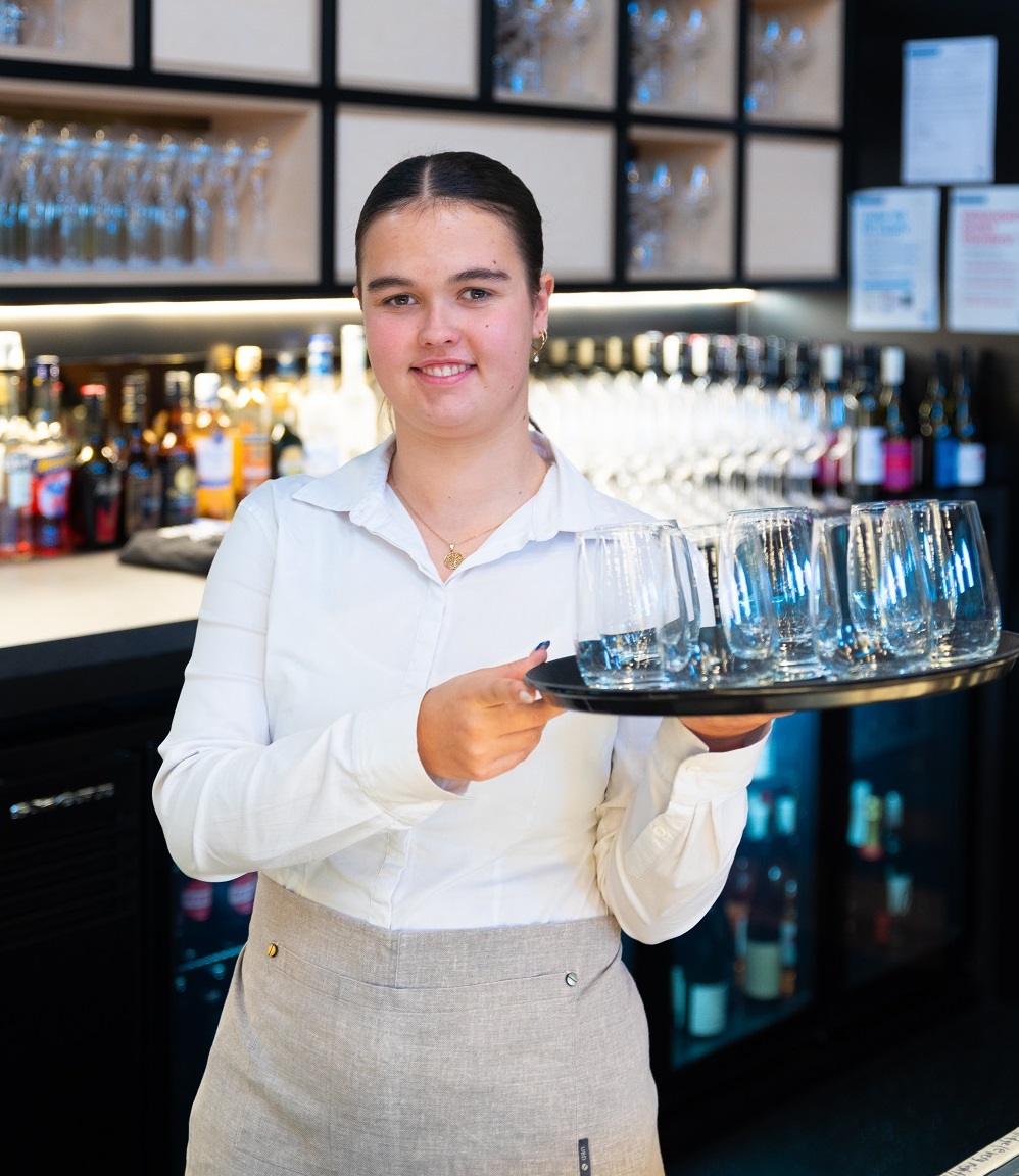 Image of student working in a hospitality/bar environment 