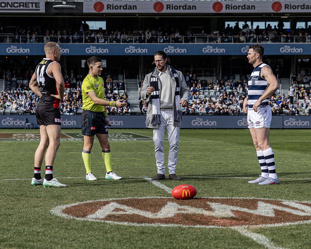 -	Gordon Alumni competition winner Mark Little tossing the coin at a Geelong Cats home game sponsored by The Gordon