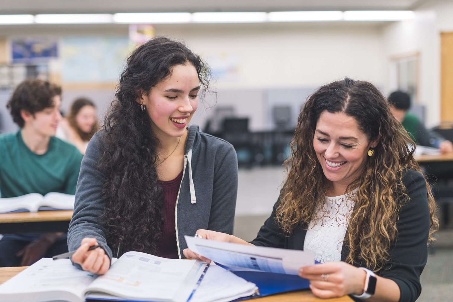 Image of two persons happily engaged in a learning environment. 