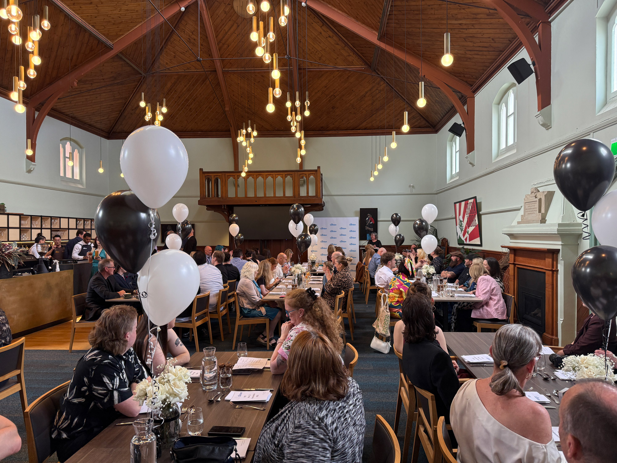 Image of a group of proud VCE students and parents celebrating graduation in The Gordons Davidson Restaurant.