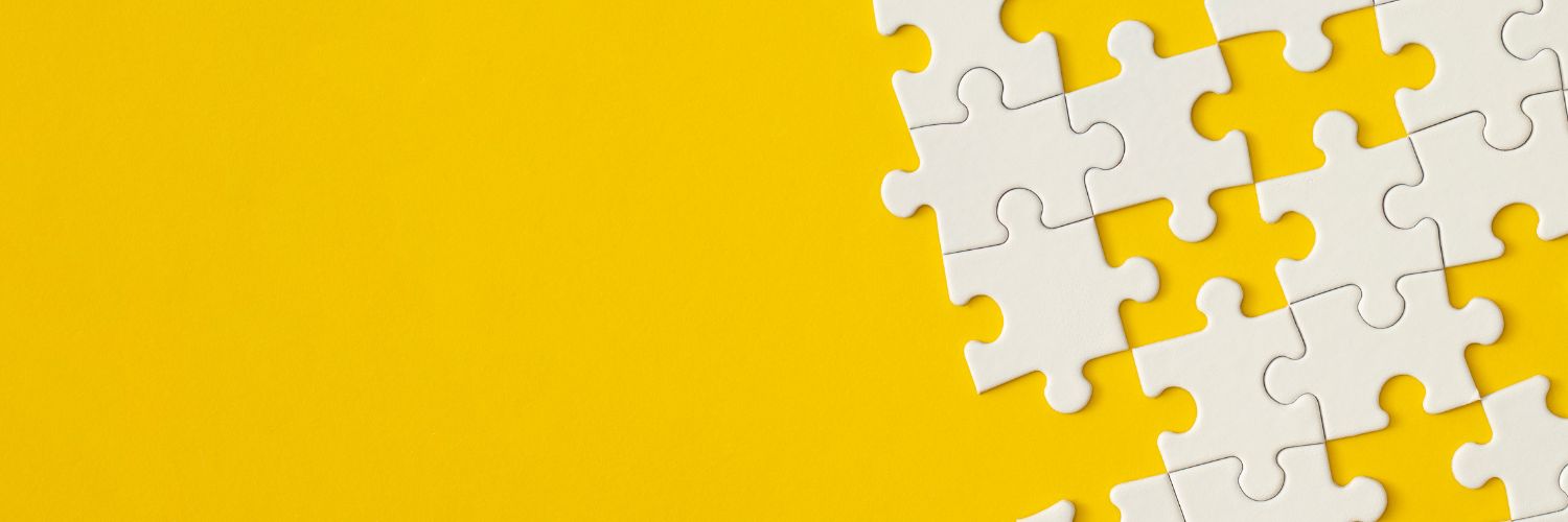 Yellow background with white puzzle pieces on the right edge.