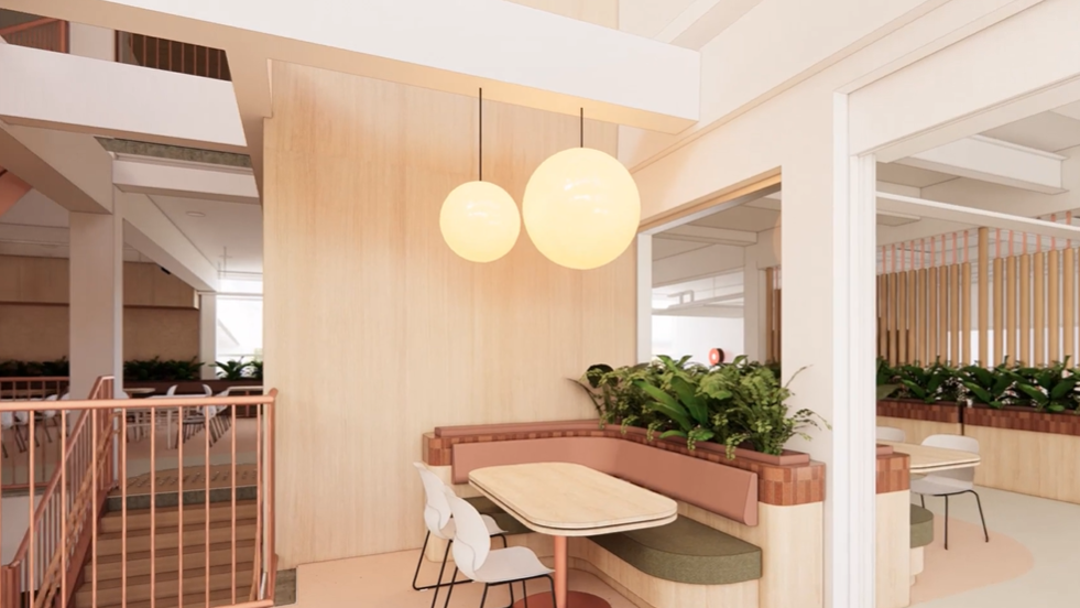 COE cafeteria with timber seating, plants and pendant lighting.